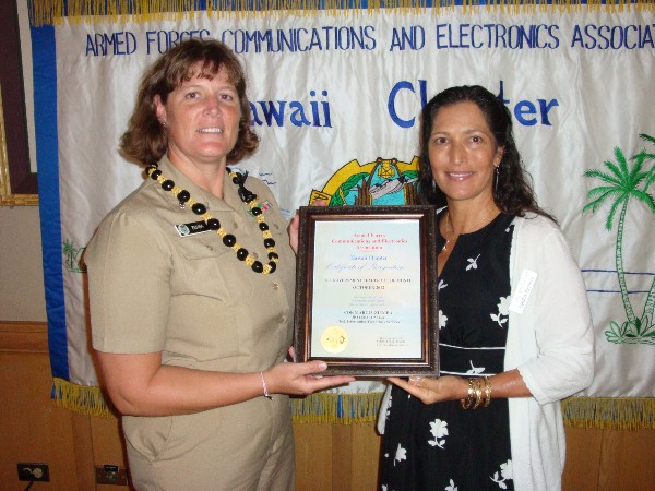 Cmdr. Marcia Ziemba, USN, chief of the IT Services Division at (J-64) Command, Control, Communications and Cyber Directorate, U.S. Pacific Command, receives the Senior Government Leader of the Month Award for October from Pacheco.